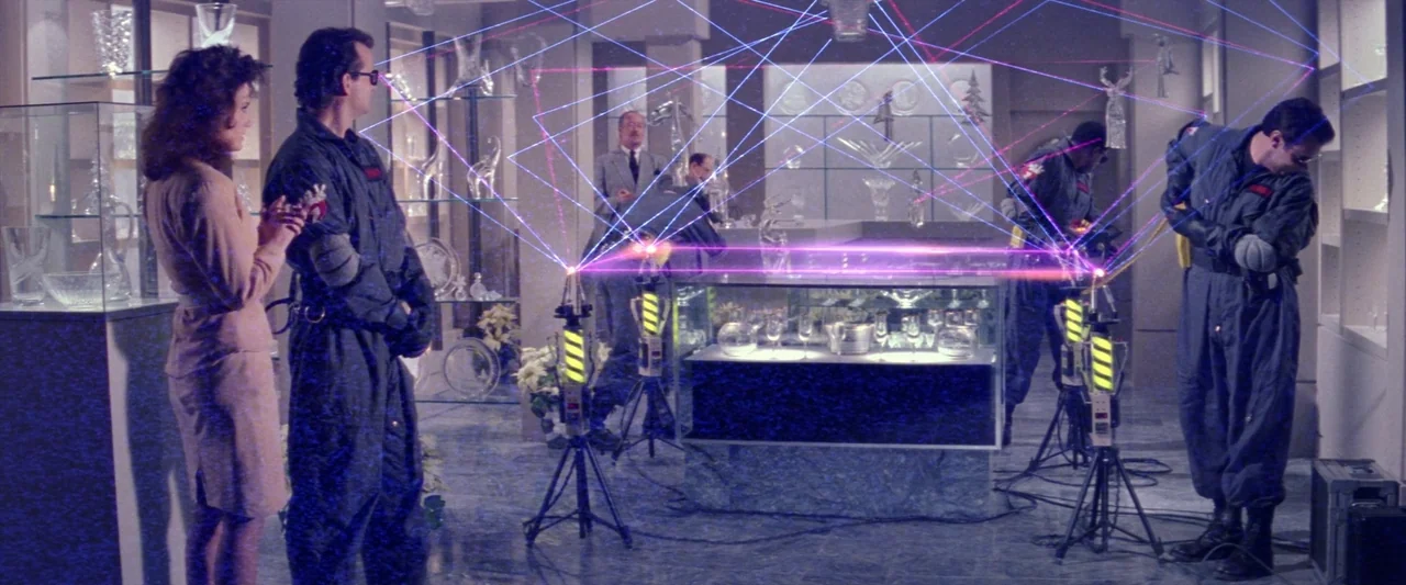 Ghostbusters 2 (1989) movie still: wide — A high-end retail shop filled with crystal display cases and polished marble floors. Several men in…