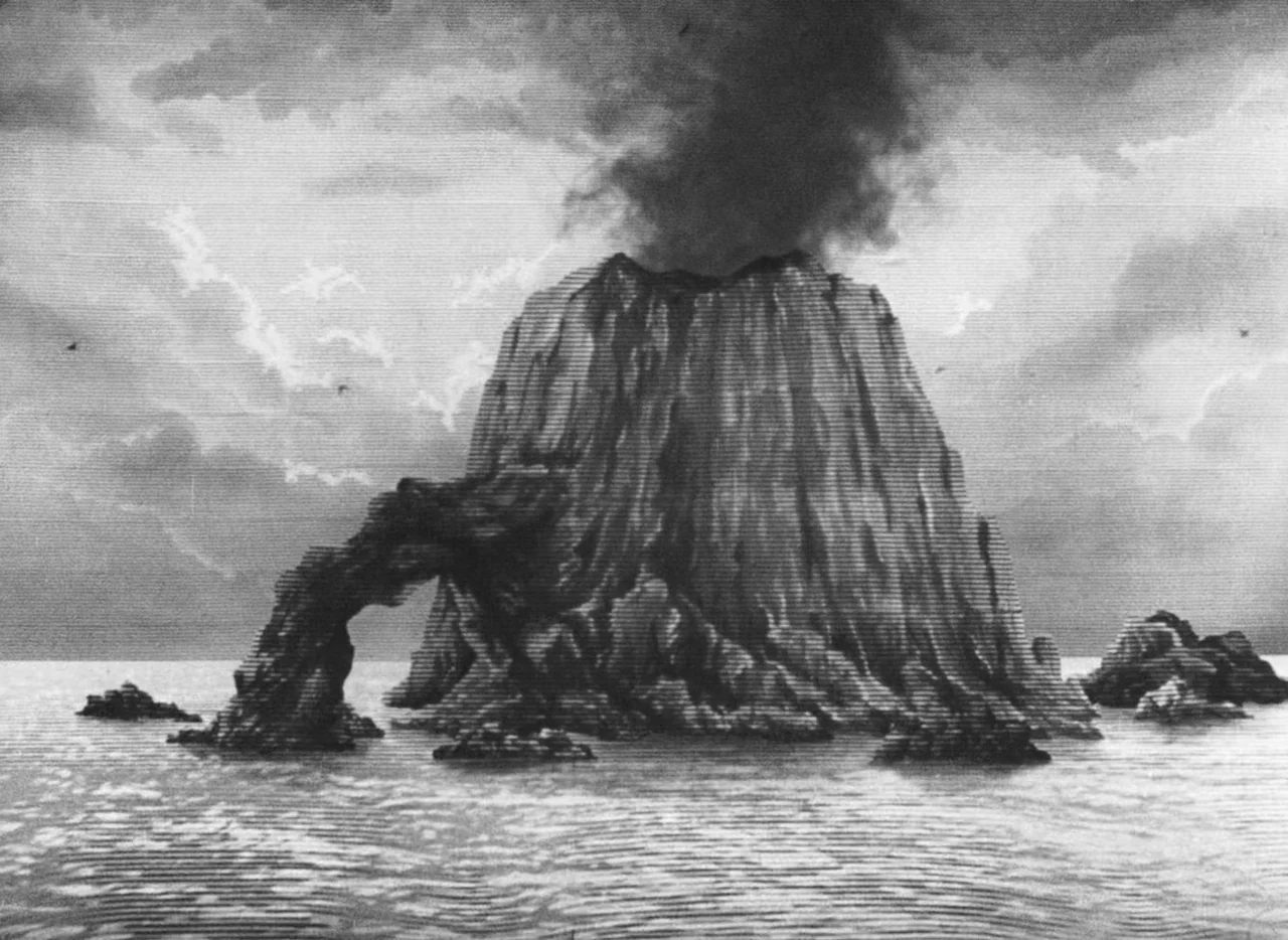 Invention For Destruction (1958) movie still: establishing — A rocky island with a natural stone archway sits in the middle of water. Dark smoke…