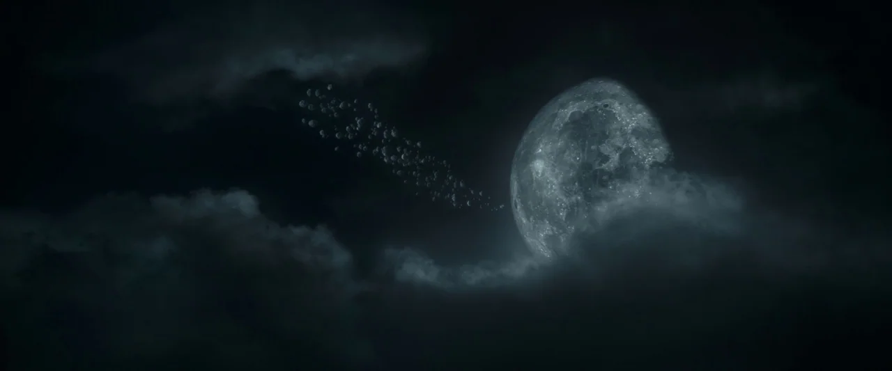 Dungeons & Dragons: Honor Among Thieves (2023) movie still: establishing — A dark night sky features thick clouds partially obscuring a large,…