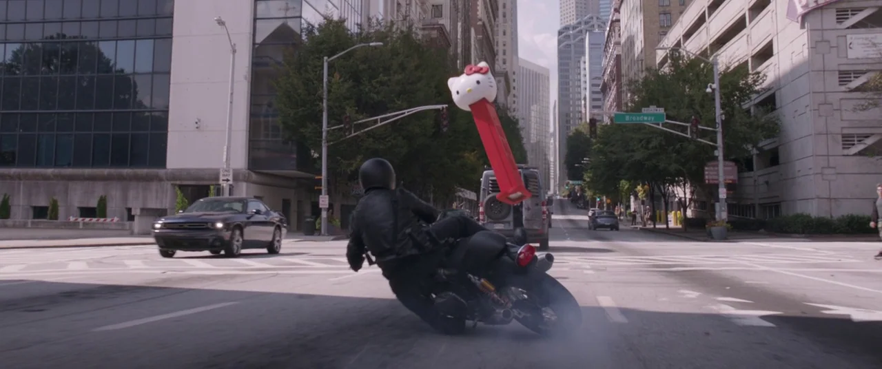 Ant-Man and the Wasp (2018) movie still: wide — A city intersection features tall concrete buildings and a street sign reading Broadway. A…