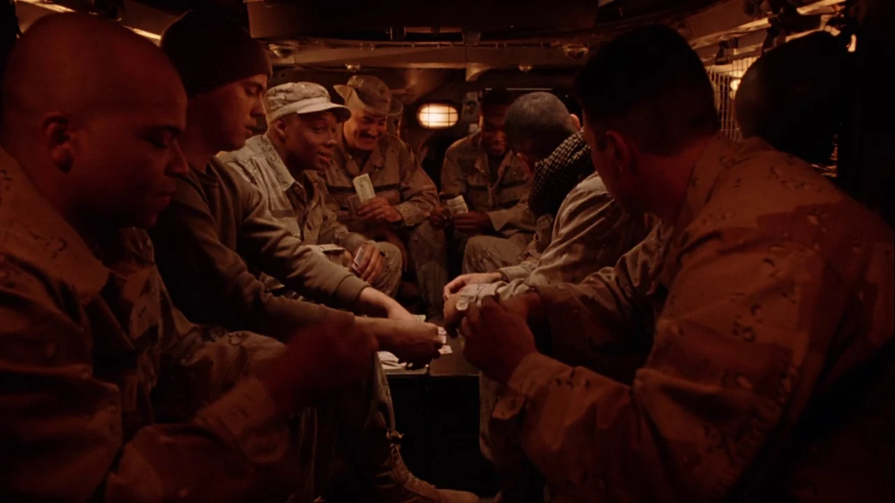 The Manchurian Candidate (2004) movie still: medium — A group of soldiers sit crowded together inside the cramped interior of a vehicle. They are…
