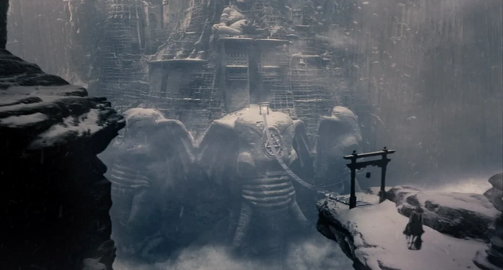 The Imaginarium of Doctor Parnassus (2009) movie still: establishing — A colossal stone temple carved into a snowy mountain face features…