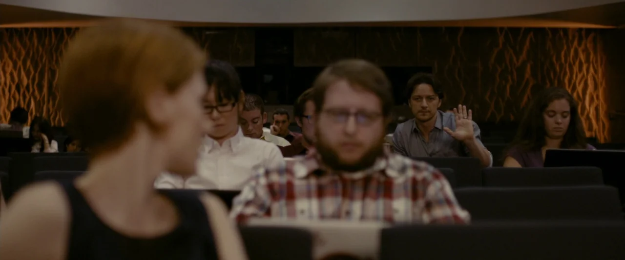 The Disappearance of Eleanor Rigby: Her (2014) movie still: medium — A modern university lecture hall with rows of dark upholstered chairs and…