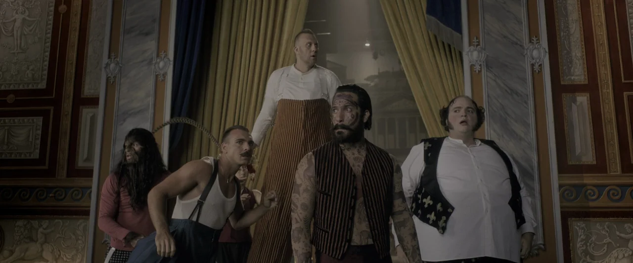 The Greatest Showman (2017) movie still: fullbody — A classic proscenium theater interior with ornate red and gold wall paneling. Five circus…
