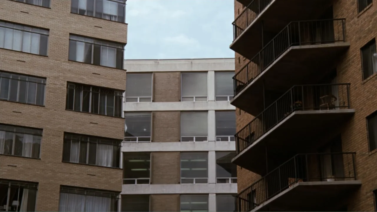 All the President's Men (1976) movie still: establishing — Three adjacent residential apartment buildings are shown from an exterior street level…
