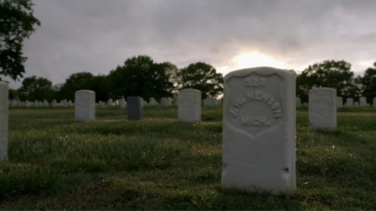 The Day the Music Died: The Story of Don McLean's "American Pie" (2022) movie still: medium — A military cemetery field contains rows of uniform…