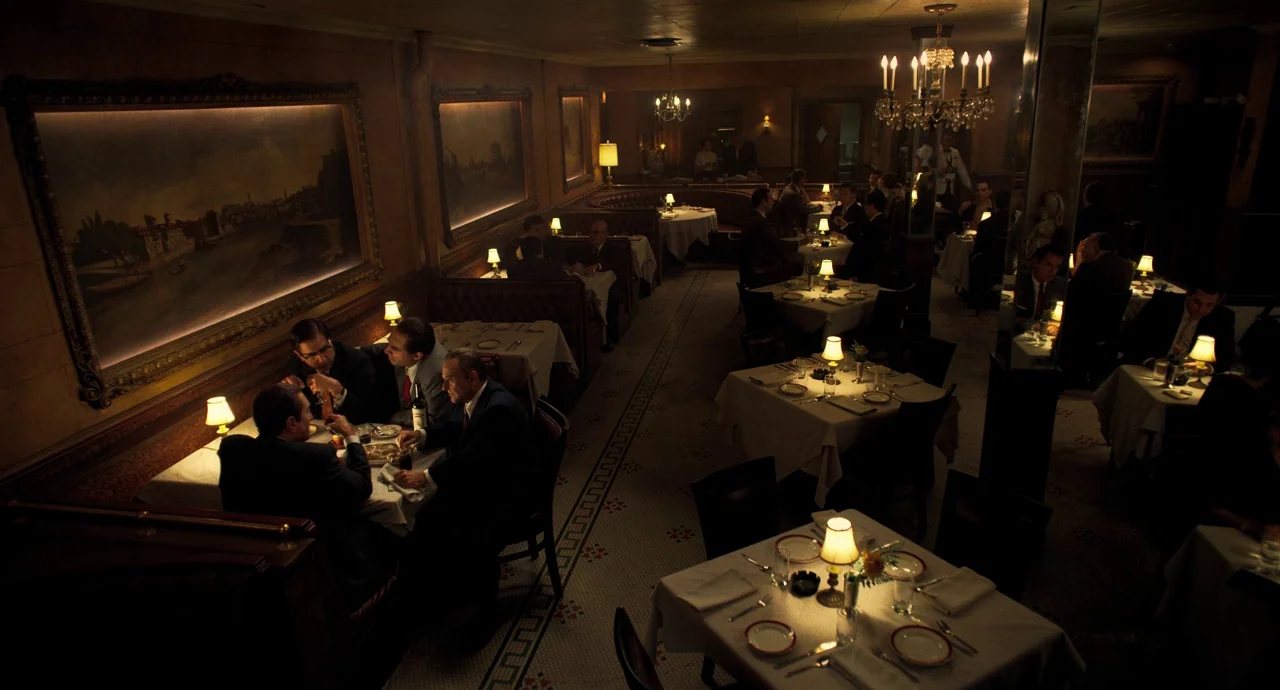 The Irishman (2019) movie still: wide — An upscale restaurant features dark wood paneling, large framed landscape paintings, and tiled floors.…