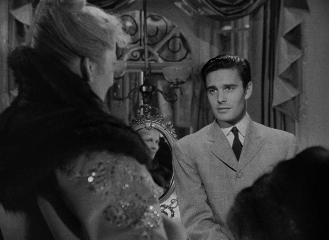 Letter From An Unknown Woman (1948) movie still: medium — An opulent interior space features ornate curtains and a small decorative mirror on the…