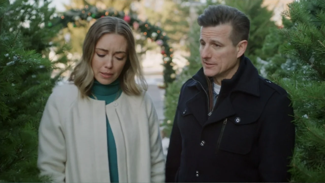 Peppermint and Postcards (2023) movie still: medium — A outdoor Christmas tree lot features dense rows of evergreen trees adorned with festive…