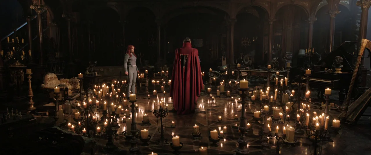 Doctor Strange in the Multiverse of Madness (2022) movie still: wide — An opulent, dim room features dark wooden panels, a piano, and elaborate…