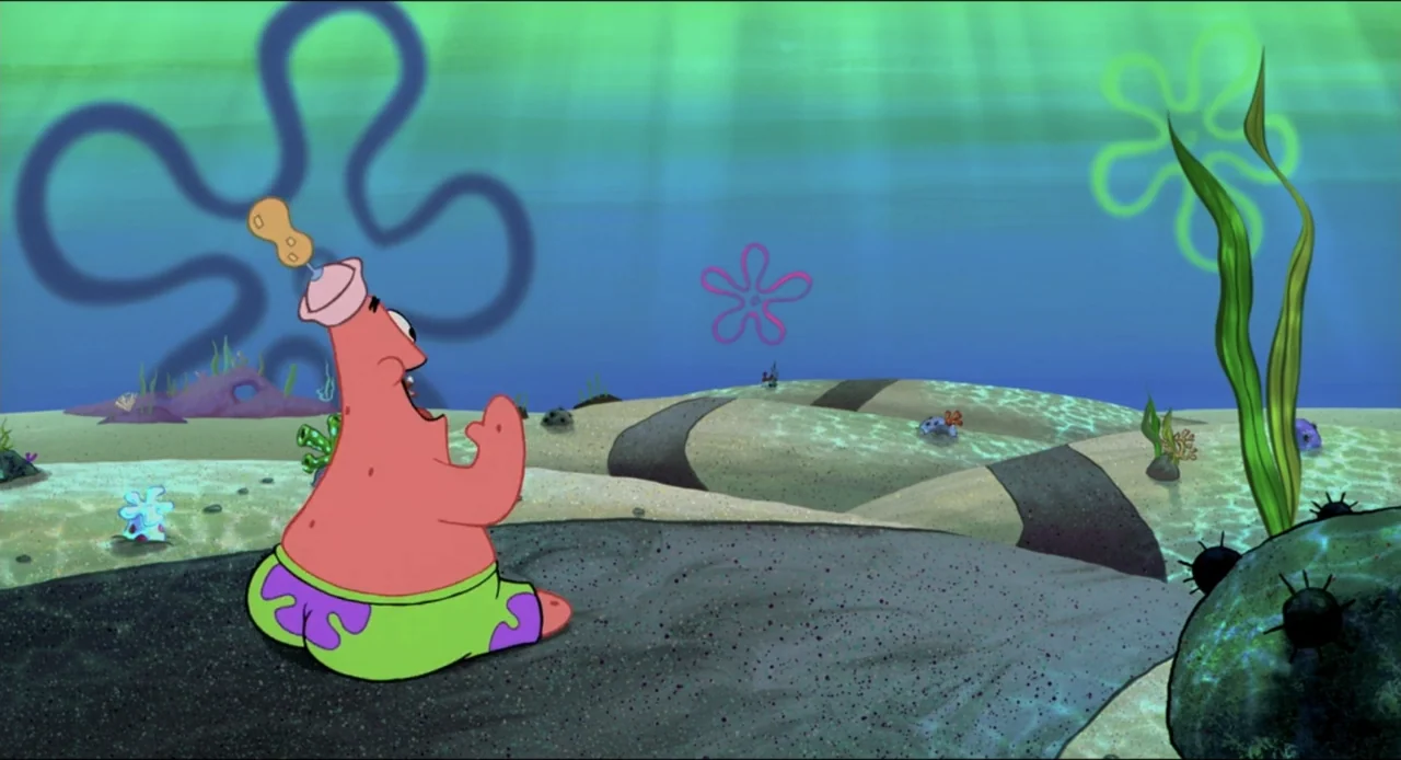 The SpongeBob SquarePants Movie (2004) movie still: medium — A sandy, sunlit seabed with green aquatic plants and stylized flower-shaped markings. A…