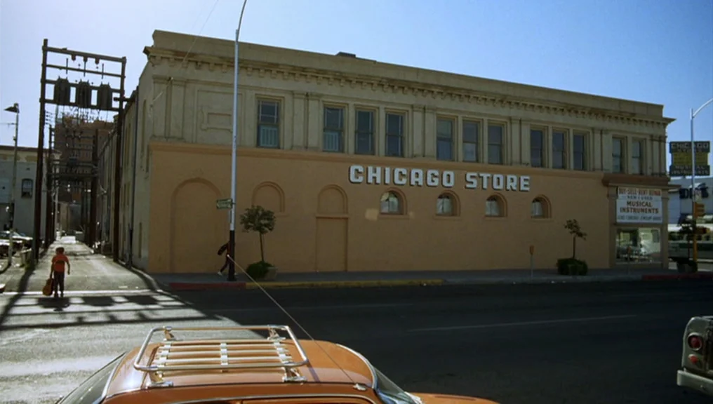 Alice Doesn’t Live Here Anymore (1974) movie still: establishing — A stucco commercial building with the text Chicago Store displayed on the facade.…