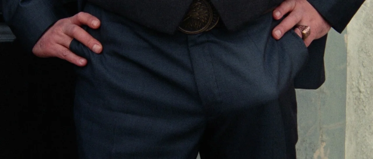 Arabian Nights: Volume 1 – The Restless One (2015) movie still: closeup — A close view of a person's midsection dressed in a dark navy business…
