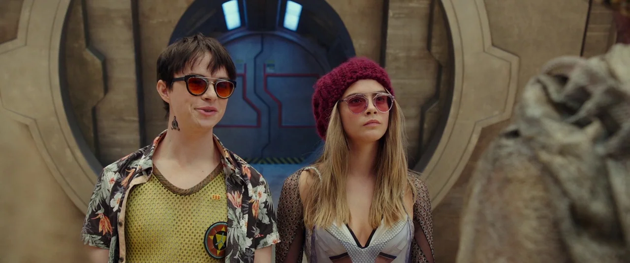 Valerian and the City of a Thousand Planets (2017) movie still: medium — A science fiction hallway features curved metallic walls and a glowing blue…