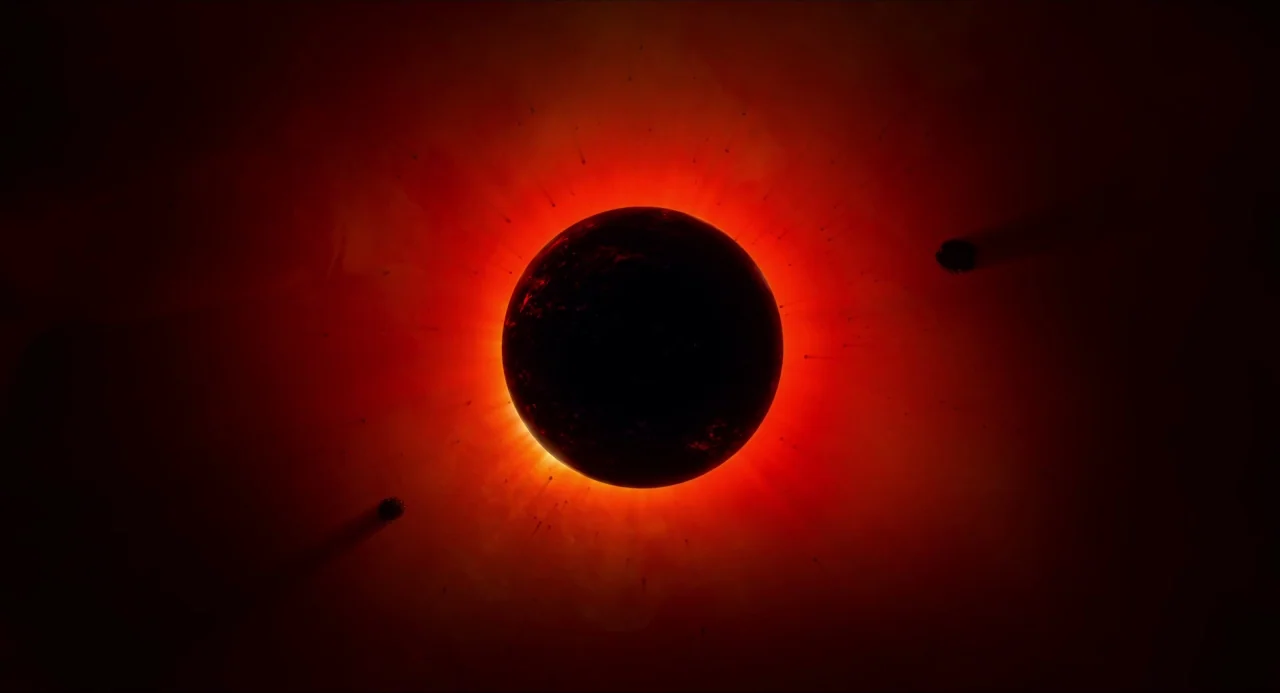 Voyage of Time (2016) movie still: establishing — A dark spherical planet is positioned centrally against a void of deep space. A vibrant red halo…