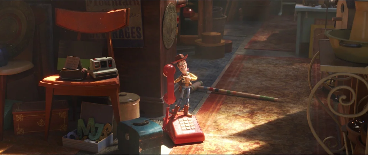 Toy Story 4 (2019) movie still: wide — A cluttered shop interior filled with wooden furniture, vintage toys, and scattered objects. A small plastic…