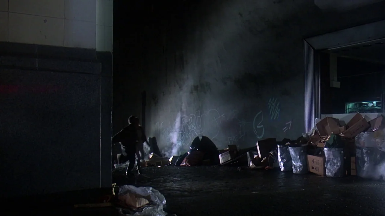 Friday the 13th Part VIII: Jason Takes Manhattan (1989) movie still: wide — A dark urban alleyway features a concrete wall covered in faded graffiti…