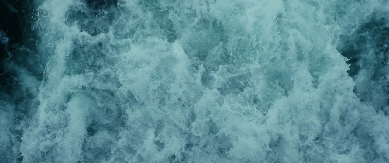 Speak No Evil (2022) movie still: establishing — Turbulent water churns violently with white foam and deep blue-grey currents throughout. The entire…