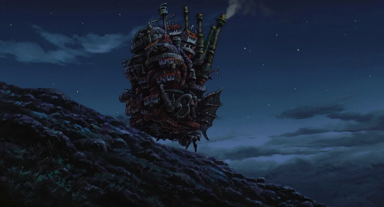 Howl’s Moving Castle (2004) movie still: wide — A sprawling mechanical castle walks across a desolate rocky hillside under a starry sky. The…
