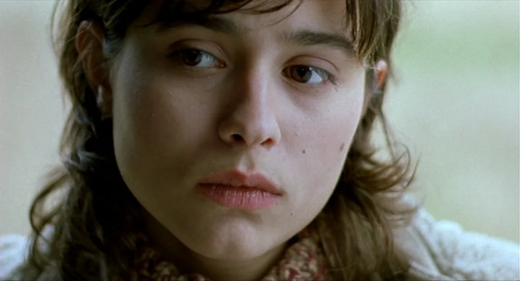 Tiresia (2003) movie still: closeup — The subject is indoors in a space with soft, diffuse lighting. The person looks forward while the camera…