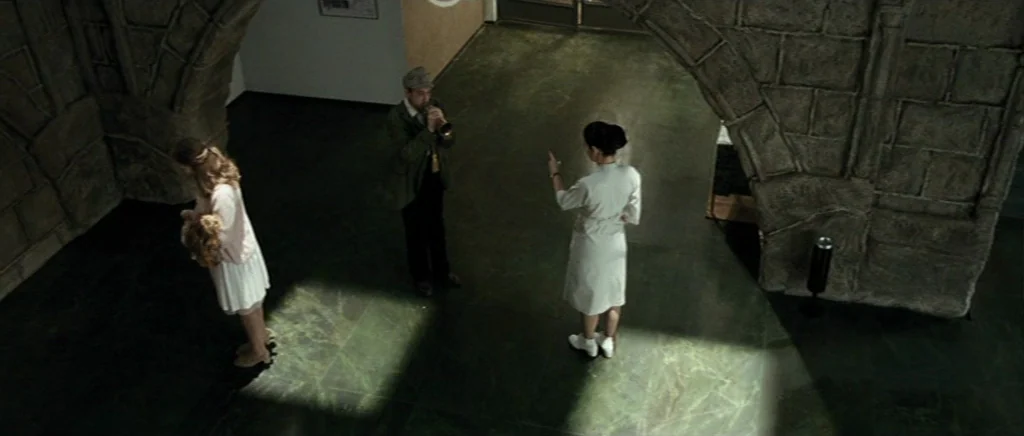 Adam Resurrected (2008) movie still: wide — A spacious room with polished green marble floors features large decorative stone masonry arches. A man…