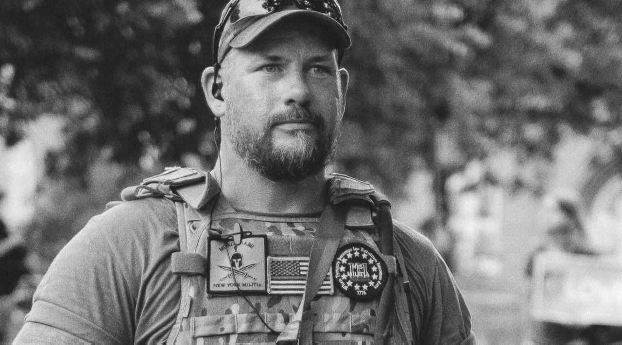 The Divided Soul of America (2019) movie still: medium — A man in tactical gear stands outside in a brightly lit environment. He looks ahead while…