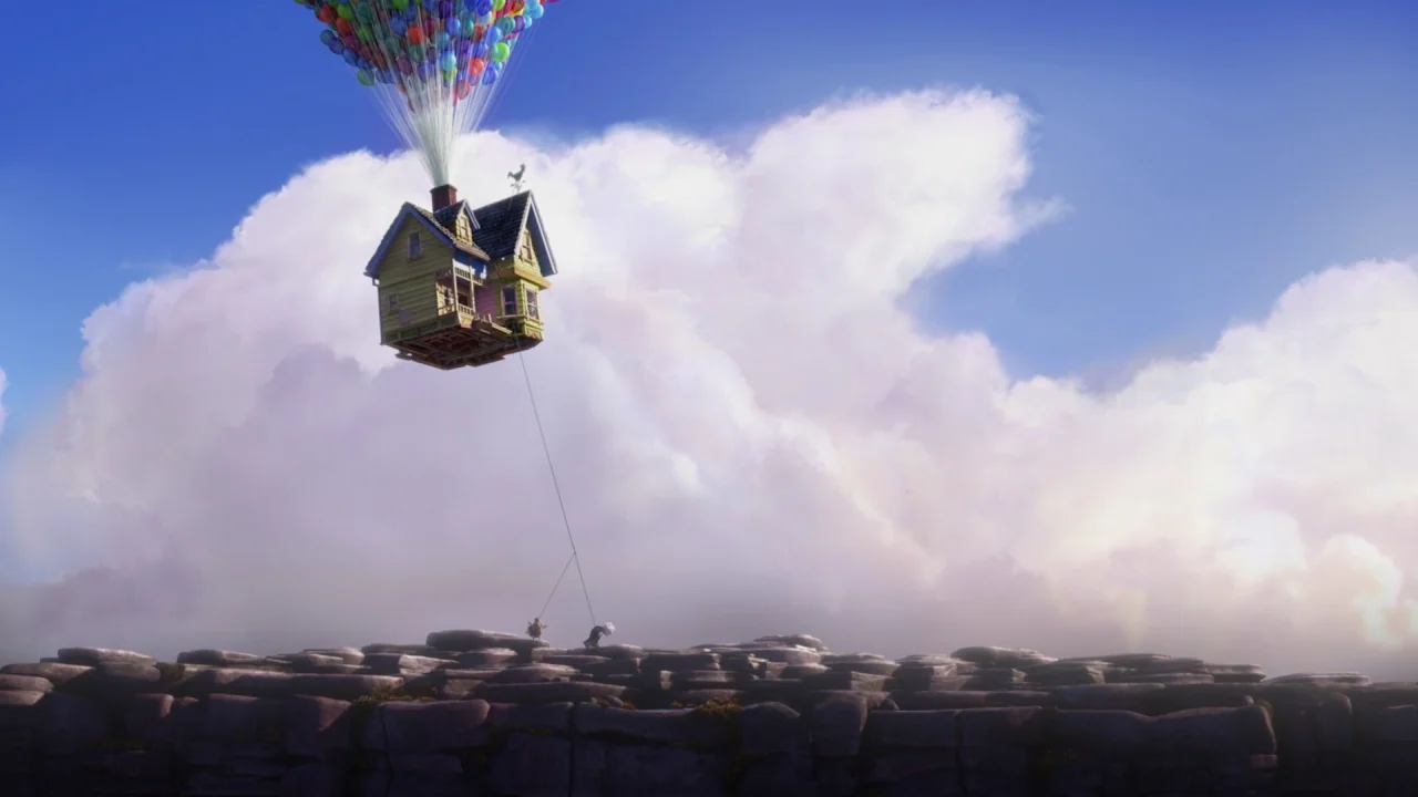 Up (2009) movie still: wide — A wooden house suspended by hundreds of colorful balloons floats above a rocky plateau. The house drifts through a…