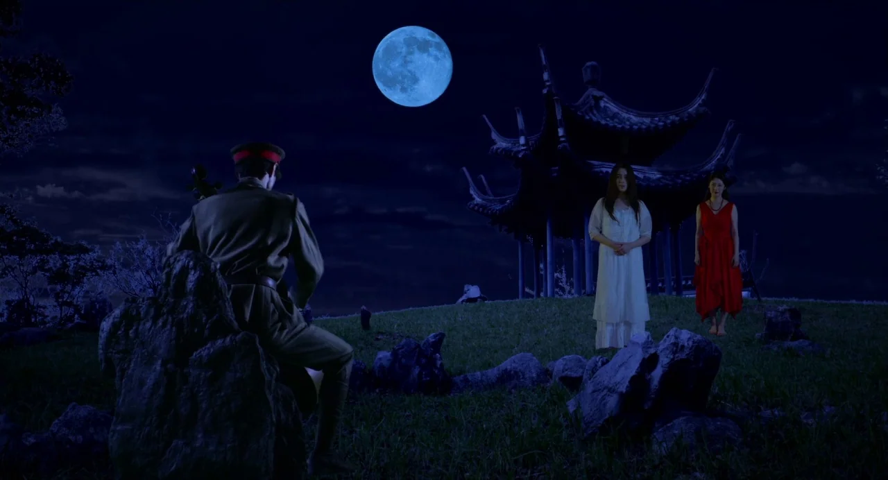 Hanagatami movie still: wide — A grassy hilltop features a dark pagoda structure silhouetted against a large, glowing full moon. A man in uniform…