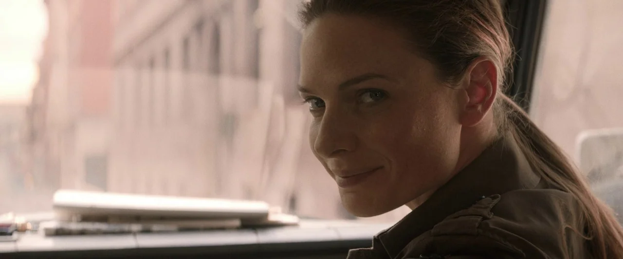 Mission: Impossible – Dead Reckoning Part One (2023) movie still: closeup — A close view inside a vehicle shows a window with a blurred urban…