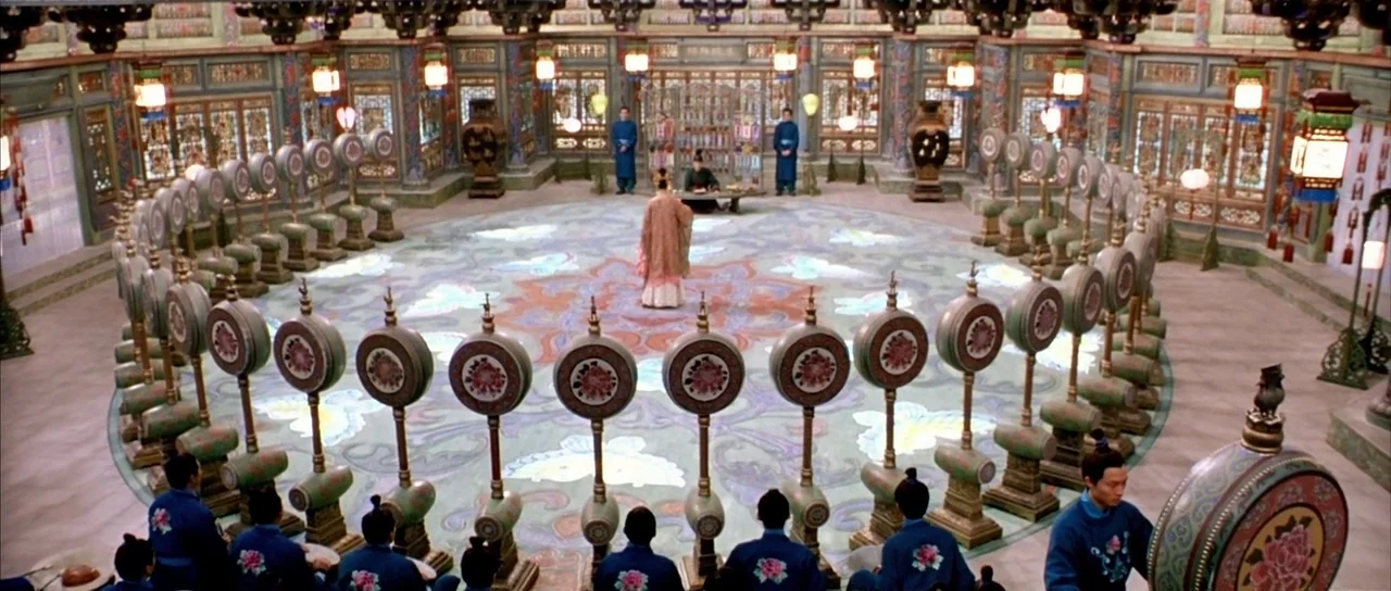 House of Flying Daggers (2004) movie still: wide — A large circular hall features intricate decorative floors and numerous upright drum instruments…