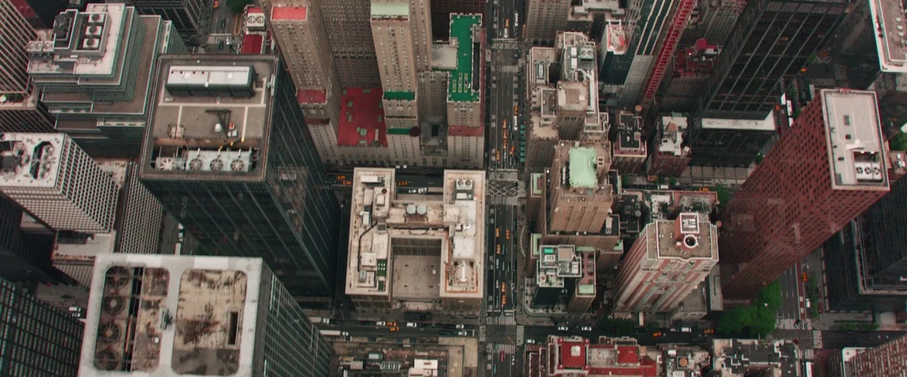 Someone Great (2019) movie still: establishing — A top-down aerial view looks down over dense urban skyscrapers and intersecting city streets. Small…