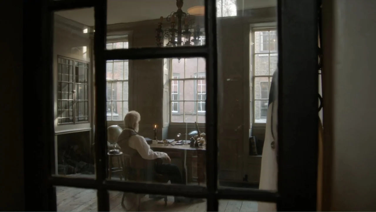 Almost Human: Rise of the Apes (2022) movie still: medium — A 19th-century study with dark wooden furniture and multiple windows overlooking an…