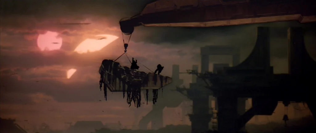 Alien 3 (1992) movie still: wide — A vast industrial landscape features massive structures silhouetted against a binary sunset. A mechanical crane…