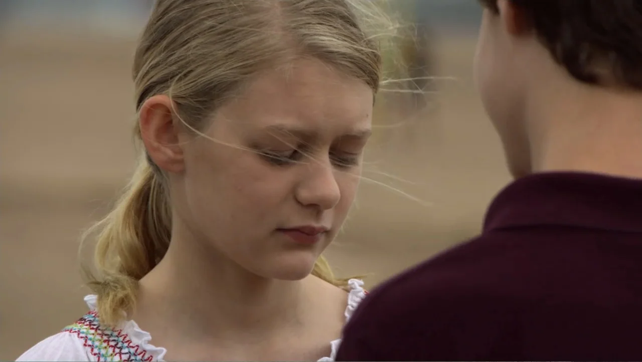 Jeremy Fink and the Meaning of Life (2012) movie still: closeup — A beach environment with a blurred sandy background under daylight conditions. A…