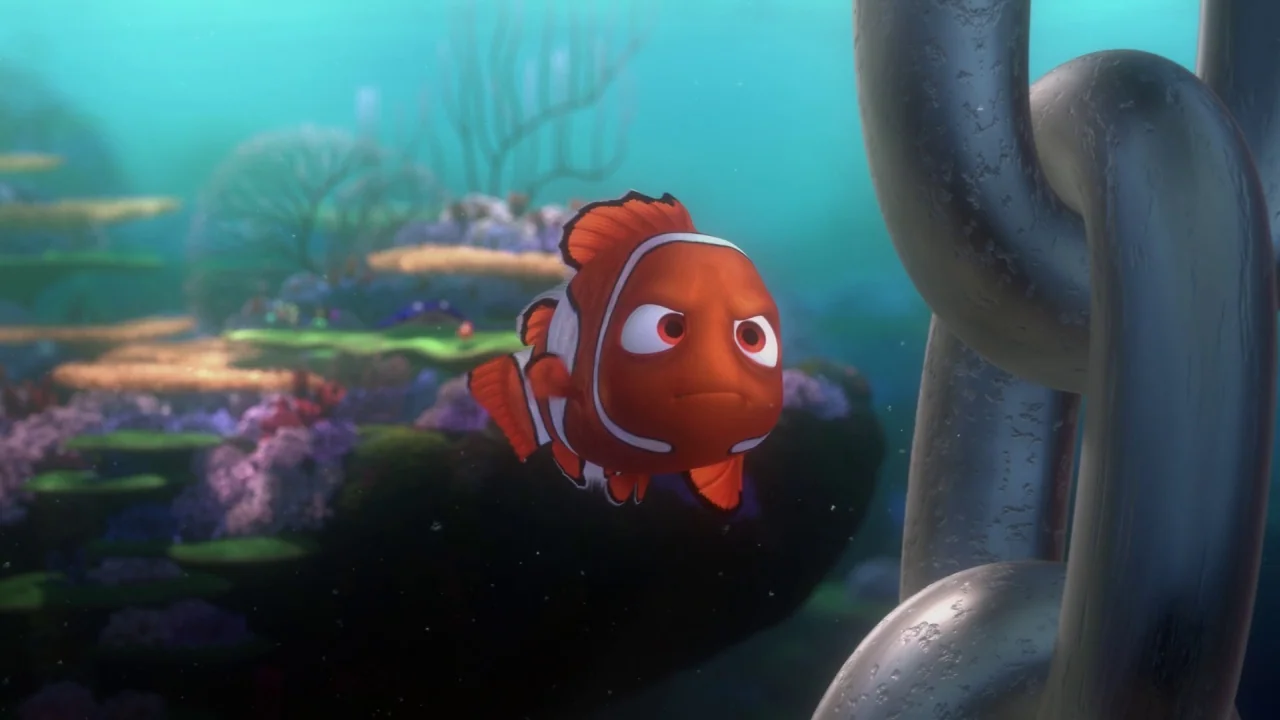 Finding Nemo (2003) movie still: medium — An underwater reef scene features vibrant coral formations and aquatic vegetation in the distance. An…