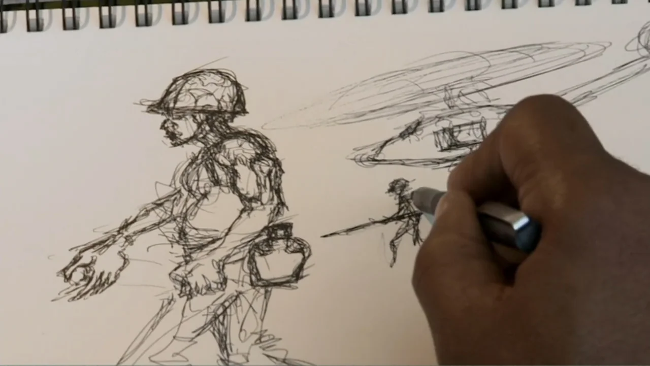 Wartorn: 1861-2010 (2010) movie still: closeup — A close-up view shows a hand sketching military figures on white drawing paper. The rough ink…