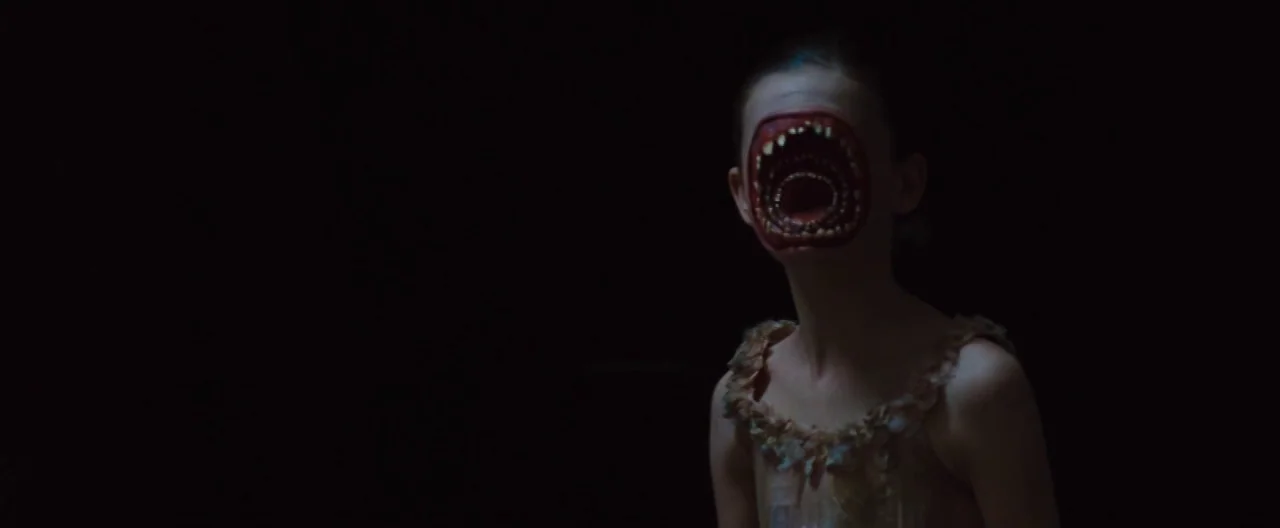 The Cabin In The Woods (2012) movie still: medium — The figure stands against an infinite black space without any visible architecture or light…