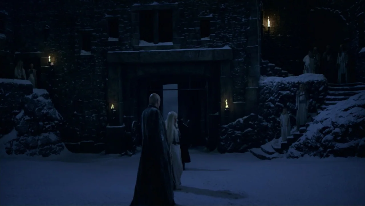 Underworld: Blood Wars (2016) movie still: wide — A dark stone courtyard is covered in snow during a cold winter night. A man and woman stand in the…