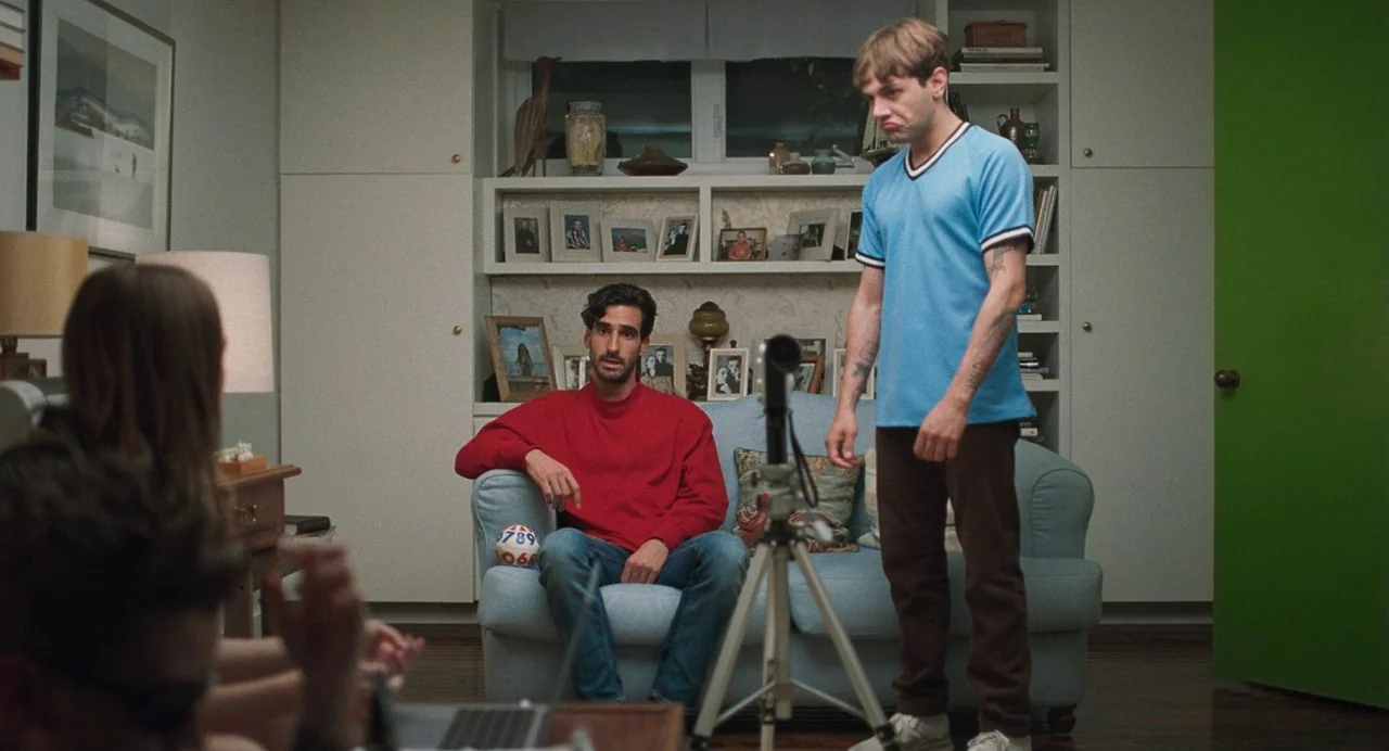 Matthias & Maxime (2019) movie still: medium — A interior residential space features white built-in bookshelves filled with framed photographs and…