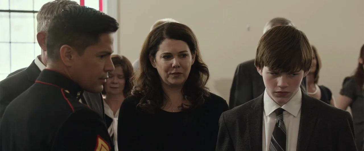 Max (2002) movie still: medium — A group of people dressed in formal attire gathers inside a bright church space. A woman in a black shirt stands…