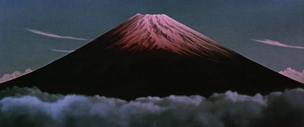 Ballad Of Narayama (1958) movie still: establishing — A massive volcanic mountain stands prominently above a sea of thick, rolling white clouds. The…