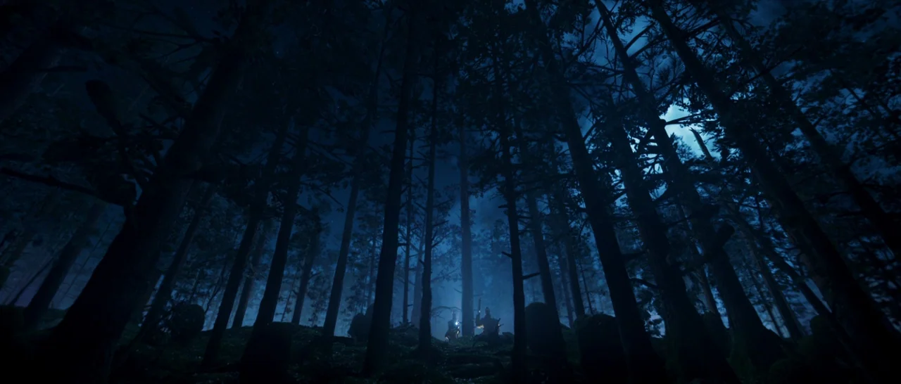 Guardians of the Galaxy Vol. 2 (2017) movie still: establishing — A dense pine forest at night is viewed from a low perspective looking upward. Two…