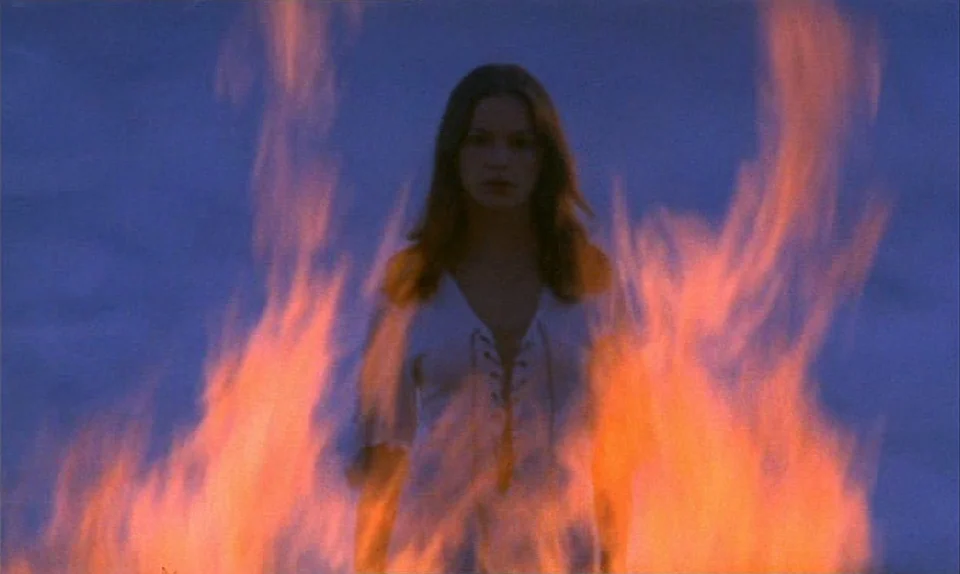 Successive Slidings of Pleasure (Glissements progressifs du plaisir) (1974) movie still: medium — A dark outdoor setting is dominated by bright,…