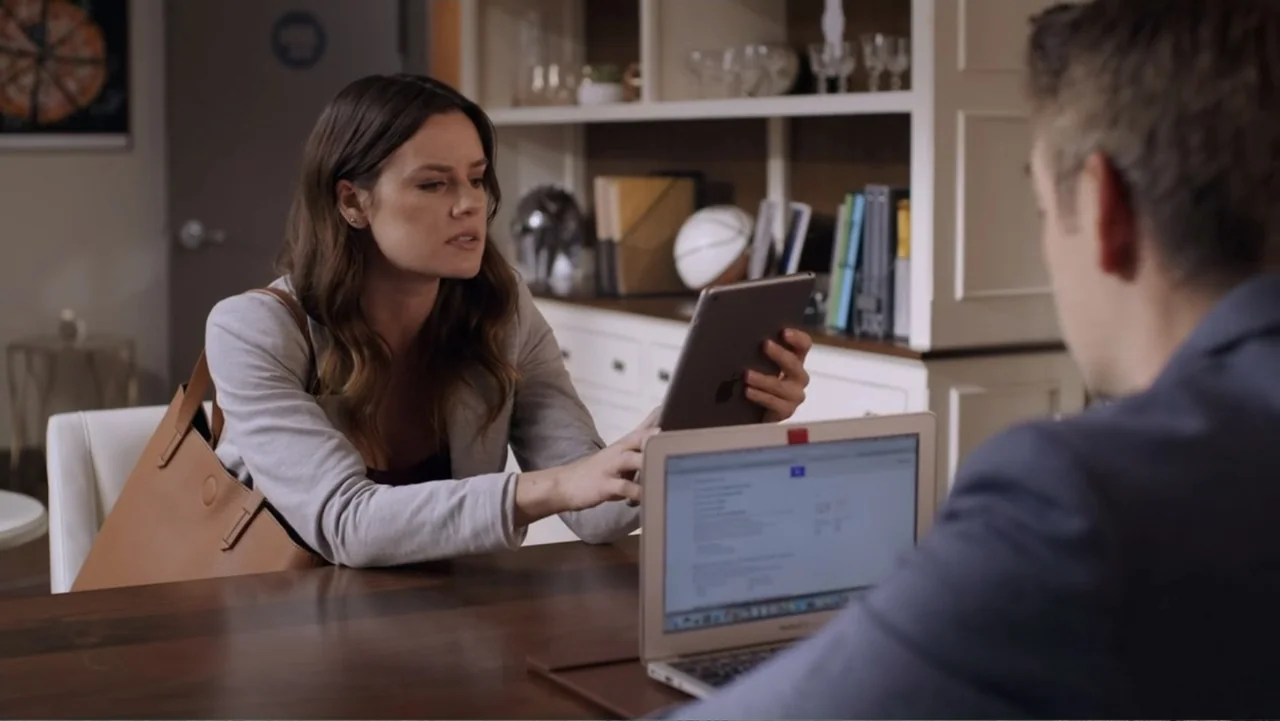 Always and Forever Christmas (2019) movie still: medium — A bright office features wooden furniture and white shelving filled with miscellaneous…