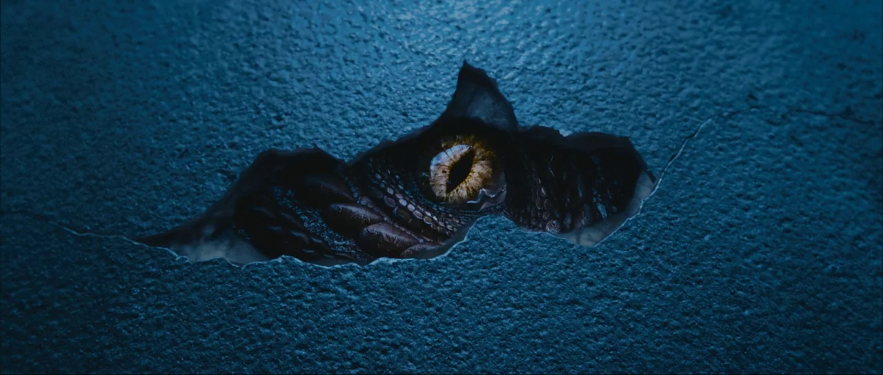The Extraordinary Adventures of Adèle Blanc-Sec (2010) movie still: closeup — A dark blue concrete wall has a jagged tear revealing a hidden space.…