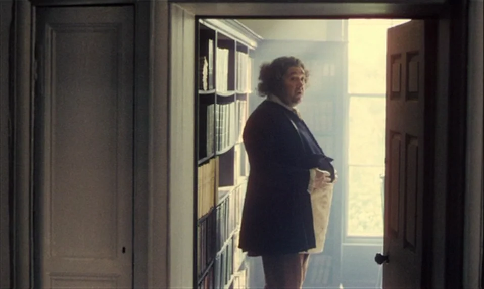 Black Jack (1979) movie still: fullbody — A historic library filled with floor-to-ceiling bookshelves along the wall. A man stands in the doorway…