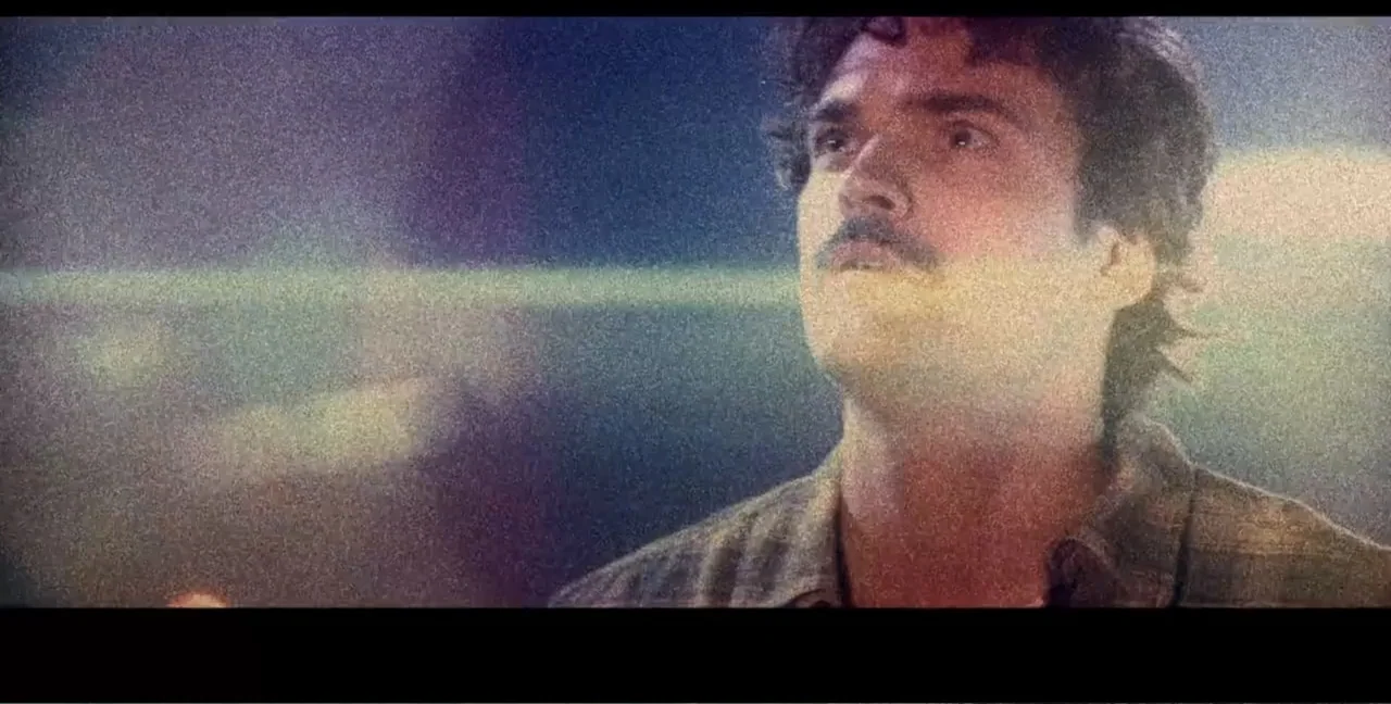 Alien Abduction: Travis Walton (2022) movie still: closeup — An outdoor night scene featuring an individual standing in an indistinct urban area. A…