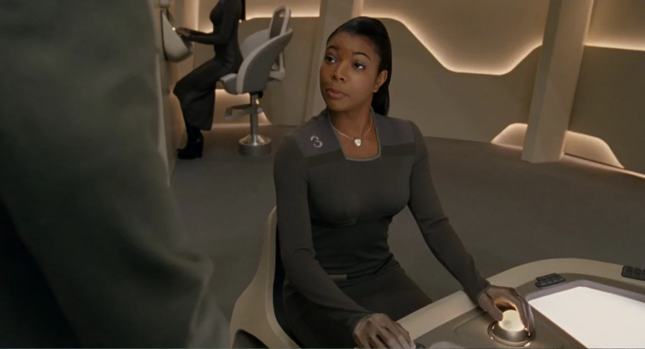 Meet Dave (2008) movie still: medium — A minimalist future interior features curved beige panels and backlit wall accents. A woman in a gray uniform…