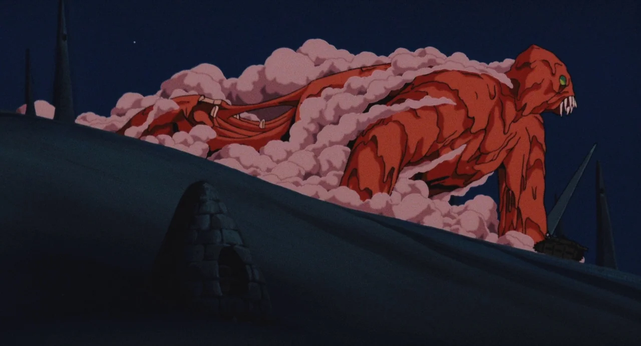 Nausicaä of the Valley of the Wind (1984) movie still: wide — A dark, hilly landscape features sharp stone spires under a night sky. A colossal red…