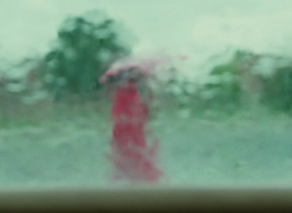 Laurence Anyways (2012) movie still: wide — A rain-streaked window pane creates heavily blurred, abstract visuals of an outdoor landscape. A faint…